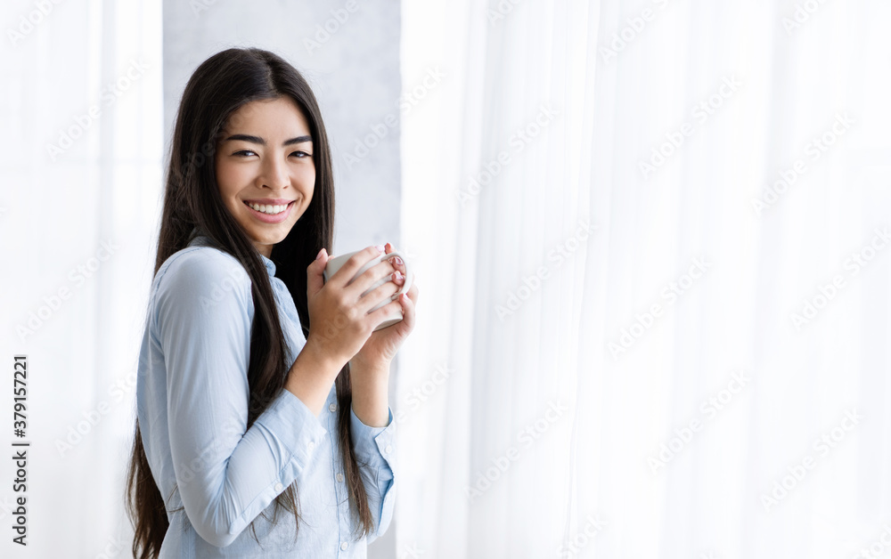 Perfect Start Of The Day. Smiling Asian Woman Drinking Coffee Near Window Perfect Start Of The Day. Smiling Asian Woman Drinking Coffee Near Window