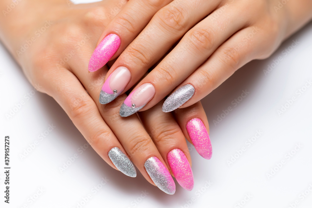 Shiny manicure on sharp long nails. Gel manicure. Pink silver French manicure with crystals.