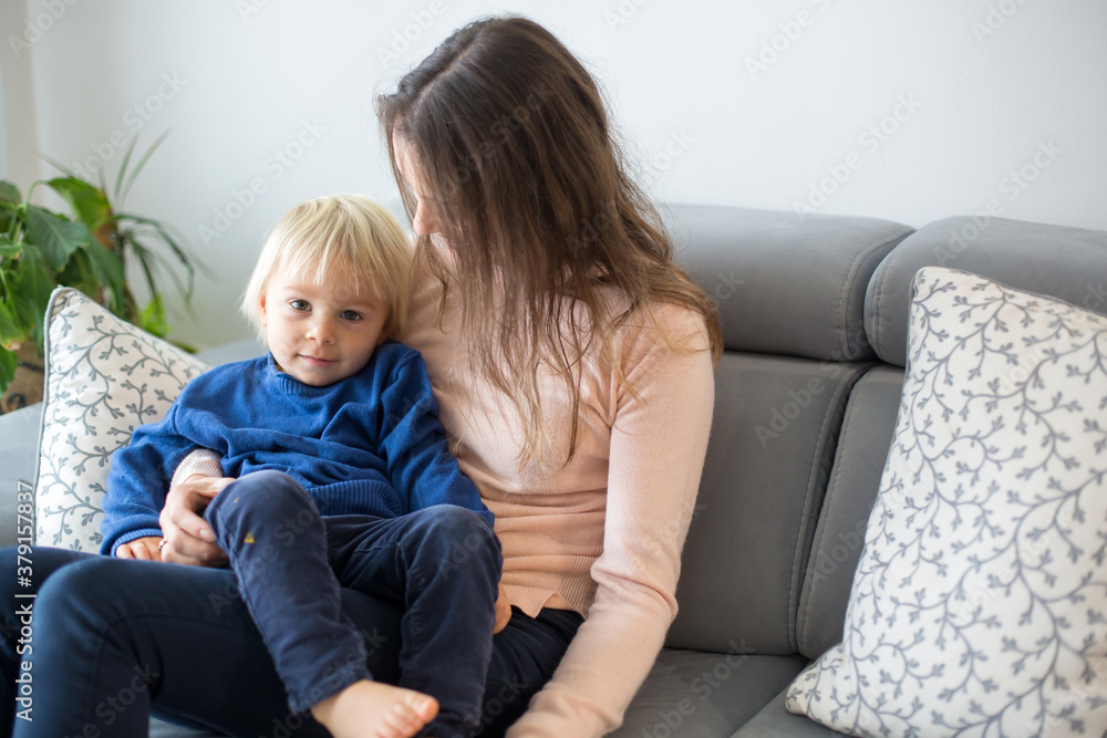 Mother, tickling her little toddler boy, child giggling at home