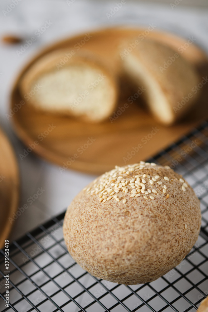 Gluten free Keto bread. Homemade ketogenic buns with sesame seeds. set on white cafe table. Gluten free Keto bread. Homemade ketogenic buns with sesame seeds. set on white cafe table.