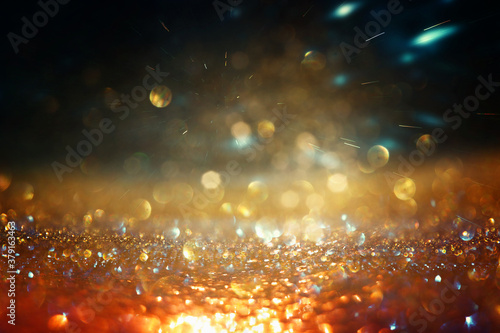 background of abstract gold and black glitter lights. defocused