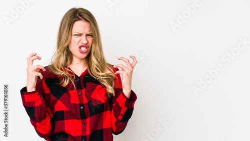 Young cauciasian woman isolated on white background upset screaming with tense hands. photo