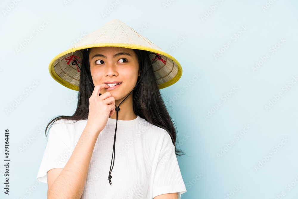 Young chinese woman wearing a vietnamese hay isolated feels proud and self confident, example to follow. Young chinese woman wearing a vietnamese hay isolated feels proud and self confident, example to follow.