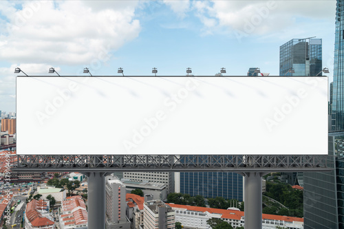 Blank white road billboard with Singapore cityscape background at day time. Street advertising poster, mock up, 3D rendering. Front view. The concept of marketing communication to promote.