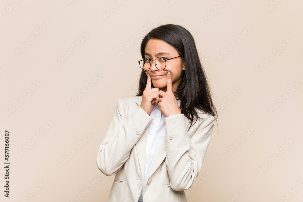 Young business chinese woman doubting between two options. Young business chinese woman doubting between two options.