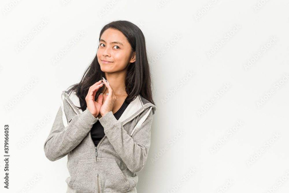 Young fitness chinese woman making up plan in mind, setting up an idea. Young fitness chinese woman making up plan in mind, setting up an idea.