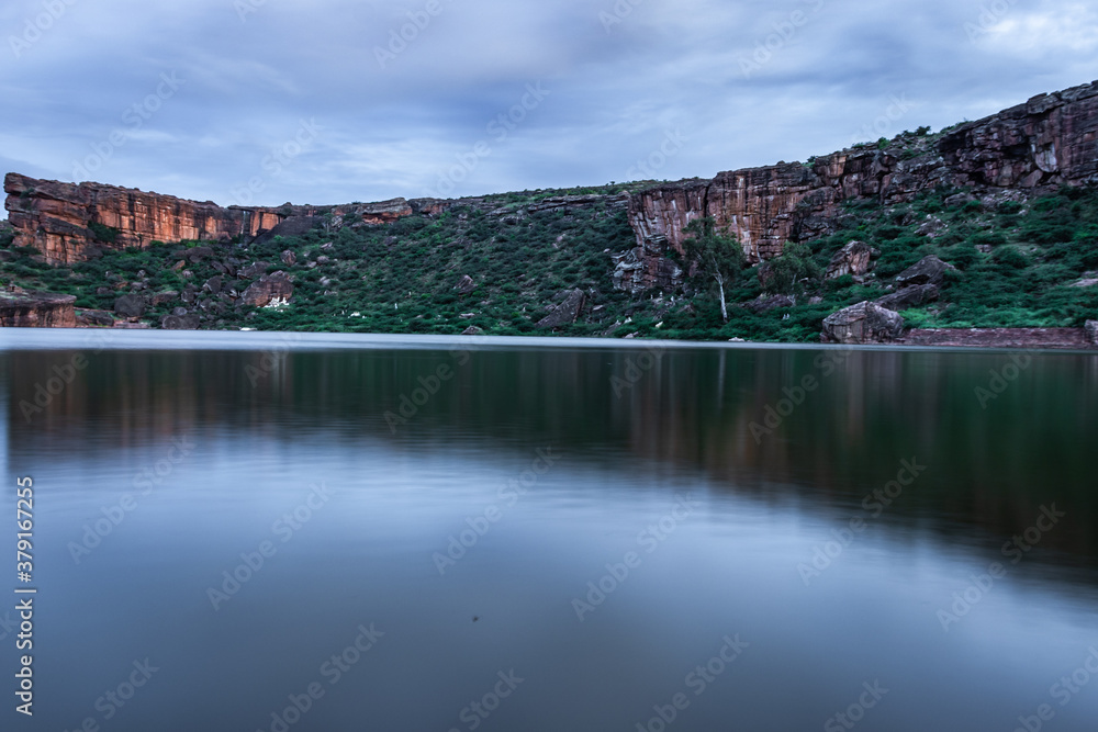 lake pristine with mountain background and bright sky long exposure shot at dusk