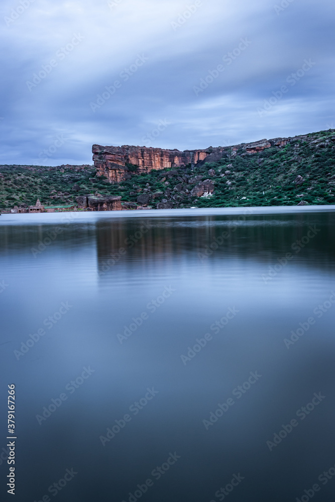 lake pristine with mountain background and bright sky long exposure shot at dusk