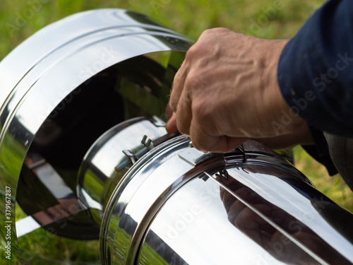installing the deflector on the heating pipe. sandwich pipes. construction. hands in the frame