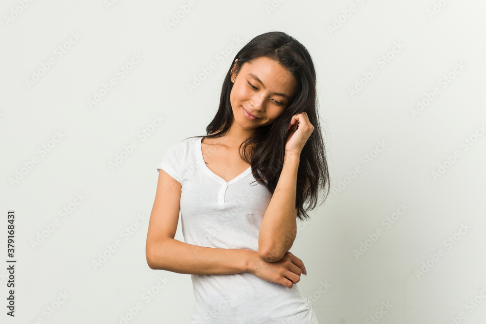 Young chinese woman posing on a white background
