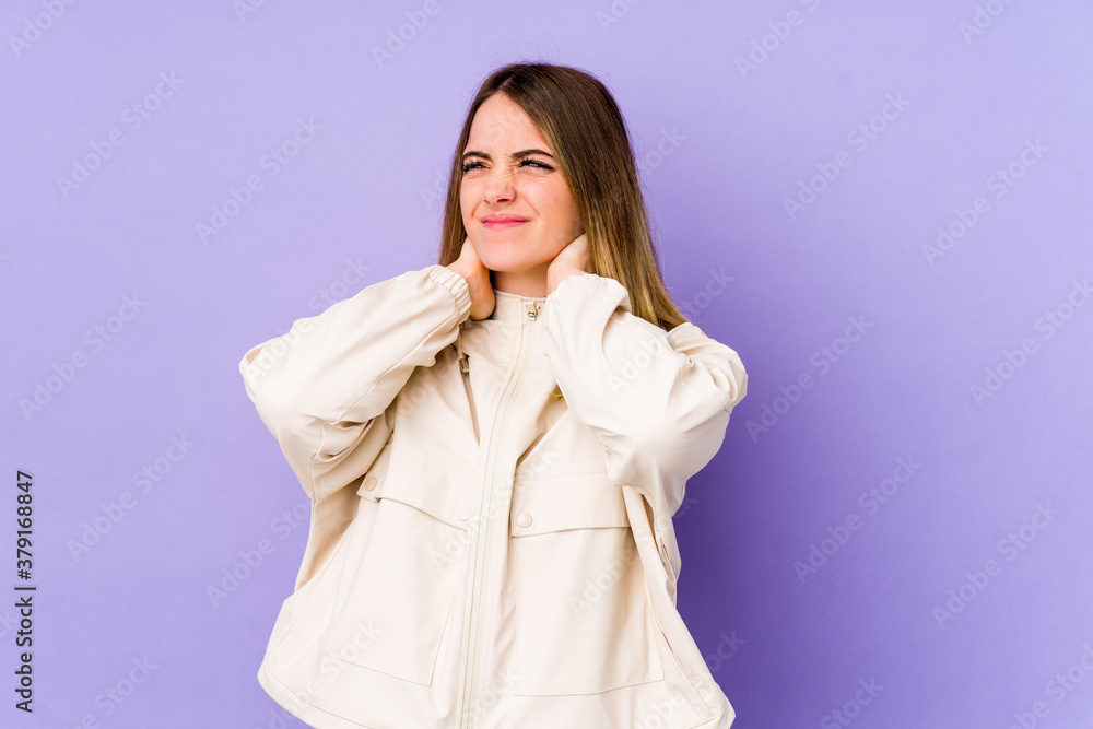 Young caucasian woman isolated on purple background suffering neck pain due to sedentary lifestyle. Young caucasian woman isolated on purple background suffering neck pain due to sedentary lifestyle.