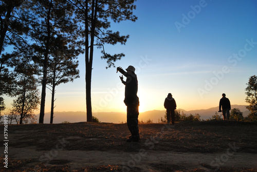 Travellers standing in the sunrise morning with silhouete landscape style
