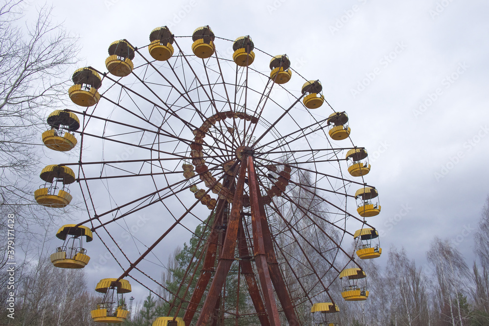 The famous Ferris wheel in an abandoned amusement park in Pripyat. Cloudy weather in the Chernobyl exclusion zone. The famous Ferris wheel in an abandoned amusement park in Pripyat. Cloudy weather in the Chernobyl exclusion zone.