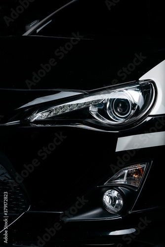 Car detailing series: Clean headlights of black sports car
