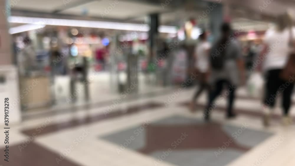 Blurred clients in the supermarket. Client with bag and cart. Consumerism concept Blurred clients in the supermarket. Client with bag and cart. Consumerism concept