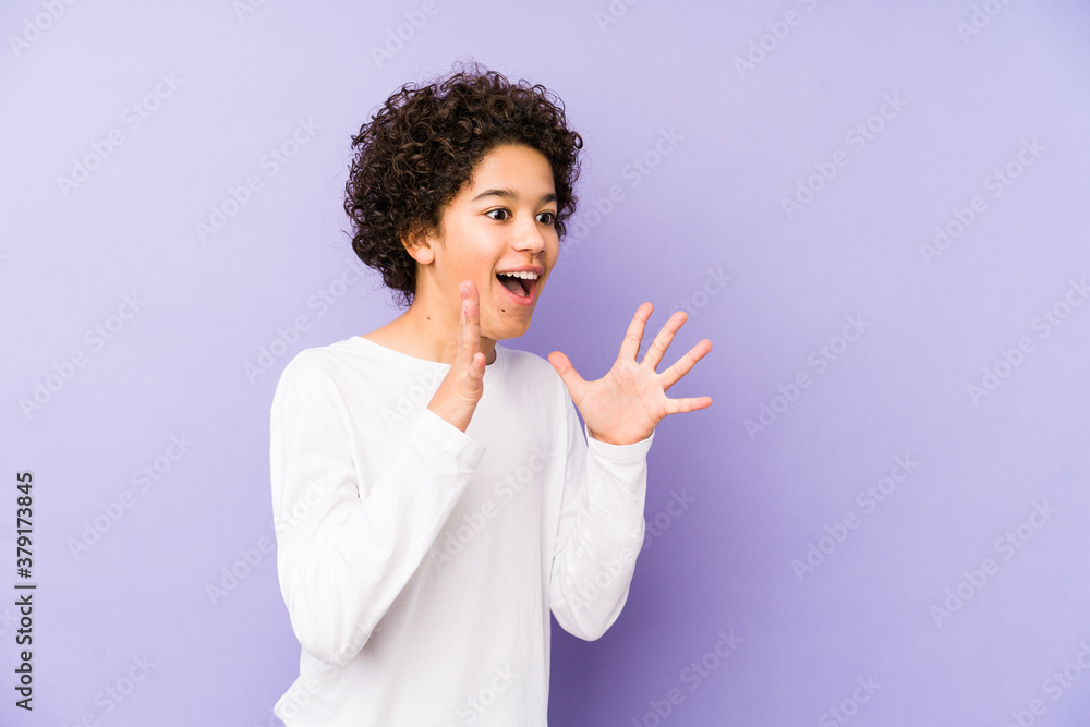 African american little boy isolated shouts loud, keeps eyes opened and hands tense. African american little boy isolated shouts loud, keeps eyes opened and hands tense.