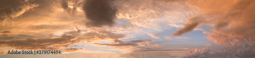 wide sunset sky panorama with yellow gray and orange clouds