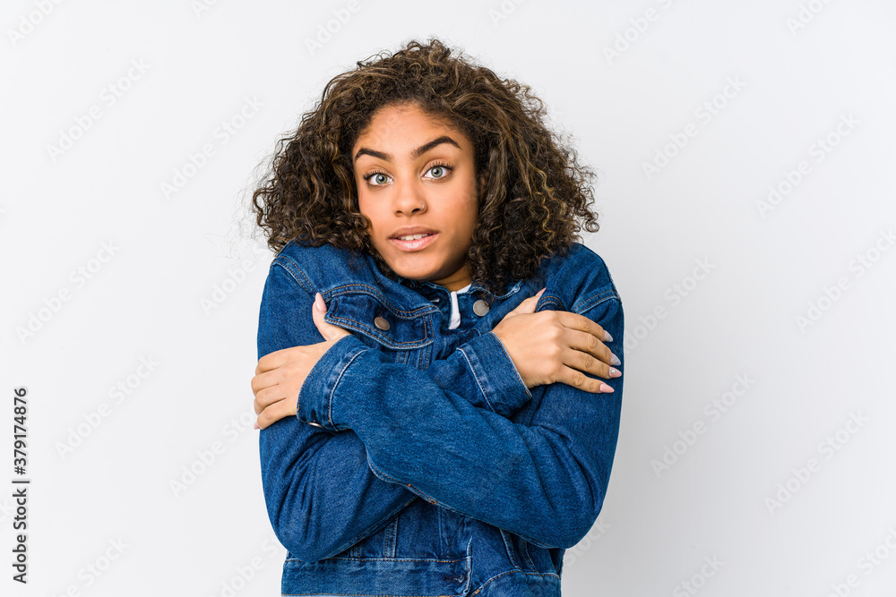 Young african american woman going cold due to low temperature or a sickness. Young african american woman going cold due to low temperature or a sickness.