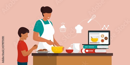Mother and son cooking cookies together at home