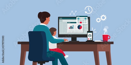 Woman working from home and taking care of her kid