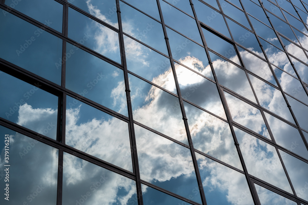 Background series: Closeup of glass skyscraper reflecting blue sky Background series: Closeup of glass skyscraper reflecting blue sky