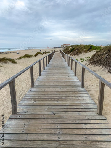 Boardwalk crossing the sand dunes in Costa Nova  Portugal with the ocean on the background