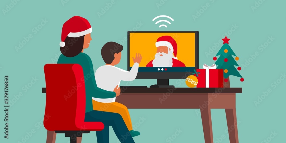 Happy child videocalling Santa with his mother Happy child videocalling Santa with his mother