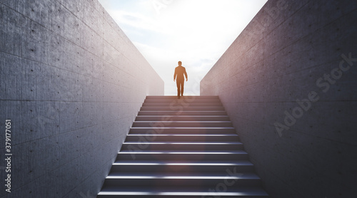 Man going upstairs towards light