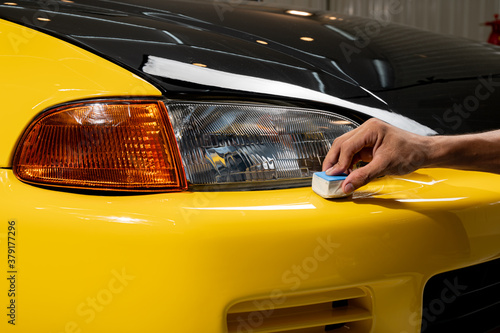 Car detailing series: Closeup of hand coating bumper