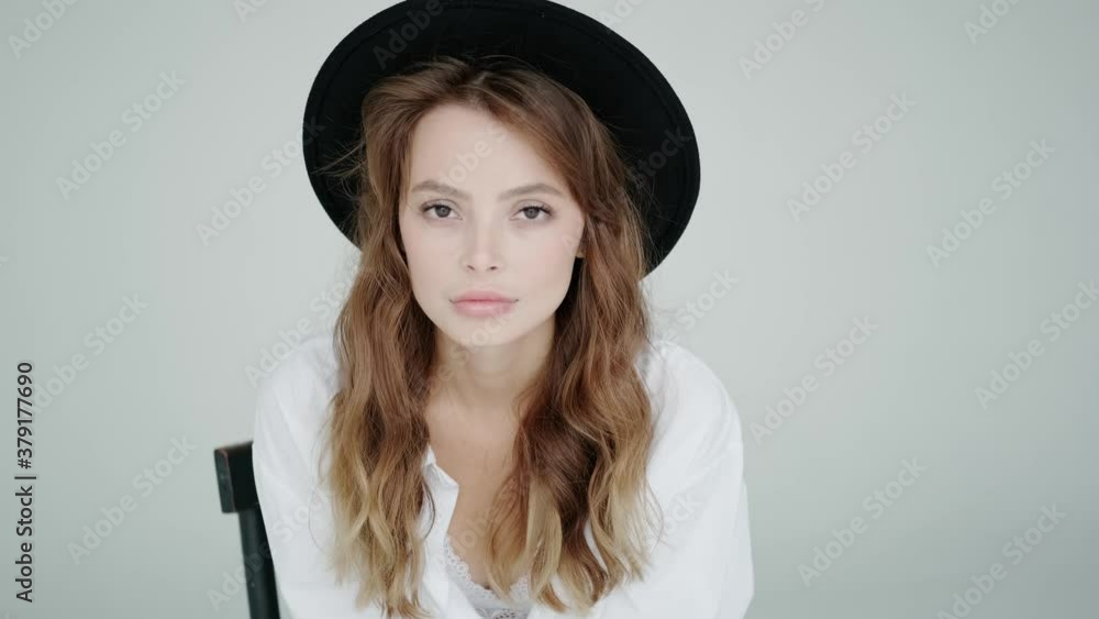 Studio portrait of a young woman in a hat on a white background Studio portrait of a young woman in a hat on a white background