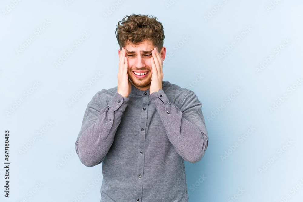 Young blond curly hair caucasian man isolated crying, unhappy with something, agony and confusion concept. Young blond curly hair caucasian man isolated crying, unhappy with something, agony and confusion concept.
