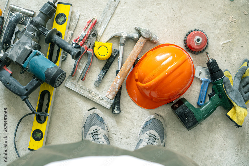 Building background with tools on the concrete floor. Building background with tools on the concrete floor.