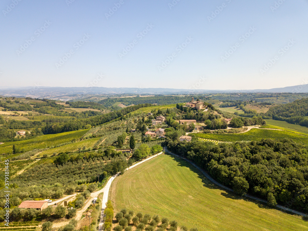 Aerial/Drone Panorama of Tuscany Landscape with vineyards and olive trees - With Montauto castle and San Gimignano - Italy