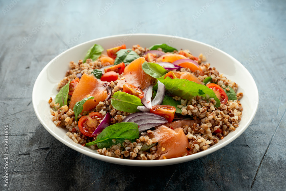 Buckwheat salad with smoked salmon, cherry tomato, red onion and greens Buckwheat salad with smoked salmon, cherry tomato, red onion and greens