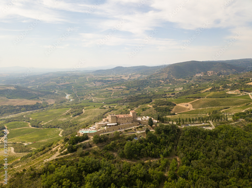 Castle in the Tuscany /Toscana aerial/drone with vineyards and olive trees in the background