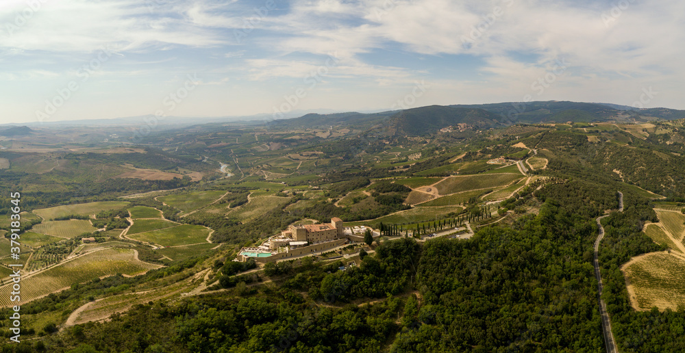 Castle in the Tuscany /Toscana aerial/drone with vineyards and olive trees in the background