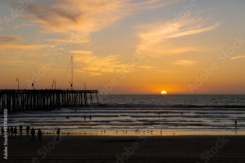 People Watching the Sunset Over Pismo Beach Pier, California USA