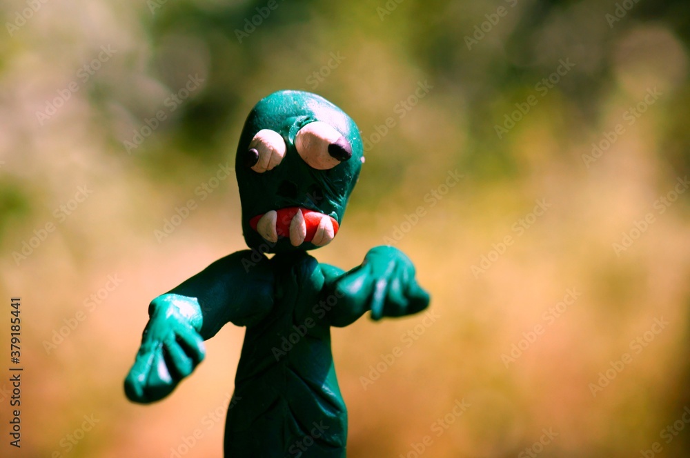 Figure of a zombie made of plasticine on a colored background. Figure of a zombie made of plasticine on a colored background.