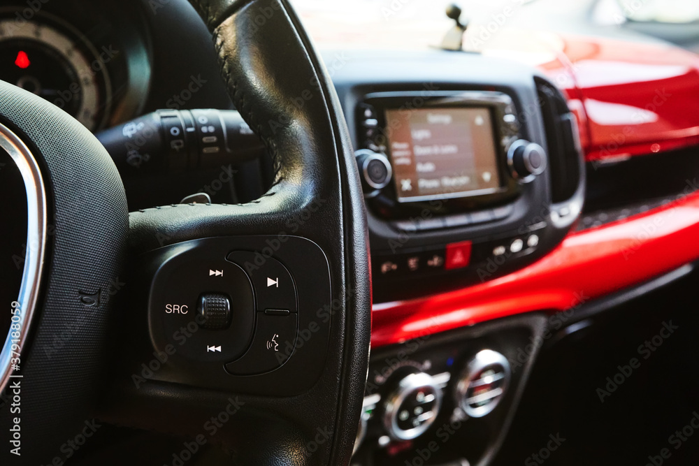 Audio system and Voice dialing control buttons on steering wheel. Car interior. Shallow dof