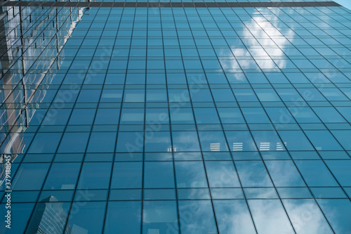 The sky is reflected in the Skyscraper windows, urban city architecture.