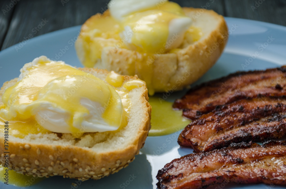 Homemade Benedict Eggs on the plate with souce Homemade Benedict Eggs on the plate with souce