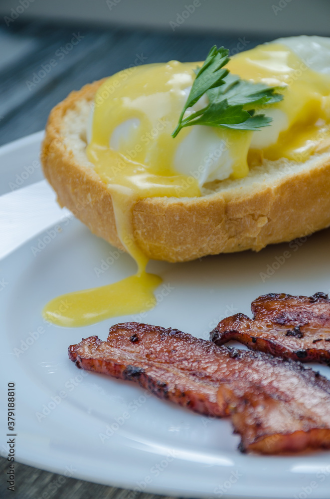 Homemade Benedict Eggs on the plate with souce Homemade Benedict Eggs on the plate with souce