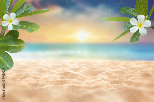Fototapeta Naklejka Na Ścianę i Meble -  Summer background Plumeria flower and foliage as frame with golden Sandy beach against with desfocus of soft wave in the sea and twilight sky as background with pastel tone