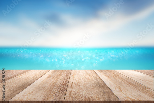 Brown wooden table top with sea sun sky scenery Summer background