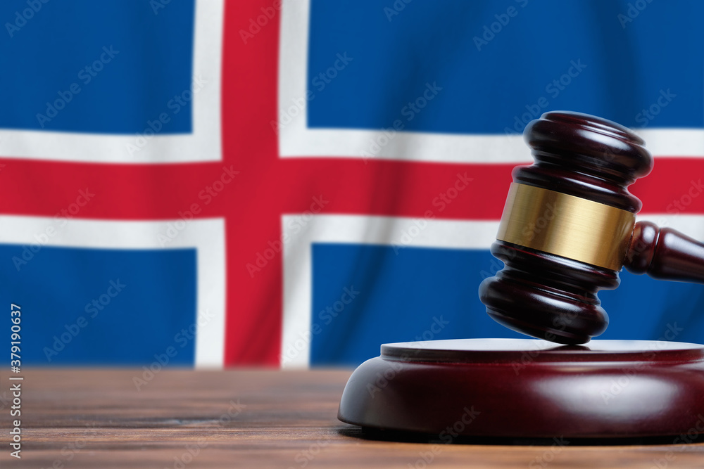 Justice and court concept in Iceland. Judge hammer on a flag background