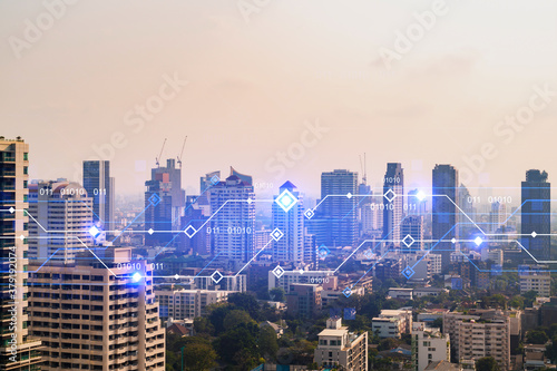 Technology hologram over panorama city view of Bangkok. The largest tech hub in Asia. The concept of developing coding and high-tech science. Double exposure.