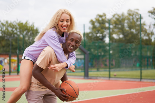 Basketball afro american man friends training caucasian woman Multiracial friendship afro guy instructor teaching female