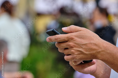 Person uses smartphone in the city in summer