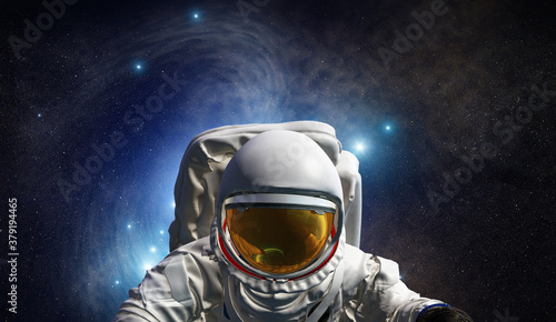 Fototapeta Naklejka Na Ścianę i Meble -  Astronaut at spacewalk. Concept of conquering the universe by the human race. Elements of this image furnished by NASA