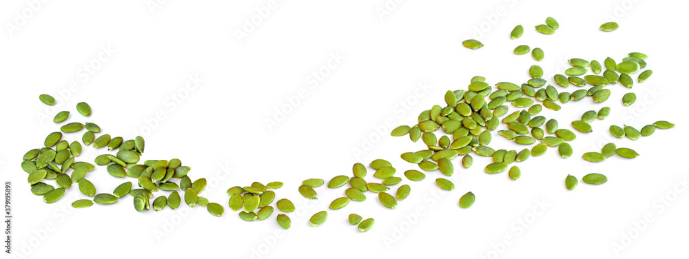 Pumpkin seeds in a row isolated on white background. Pile of green seeds Pumpkin seeds in a row isolated on white background. Pile of green seeds